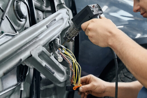 Technician working on car door mechanism to fix a faulty electric window - Car electric window not working Nottingham
