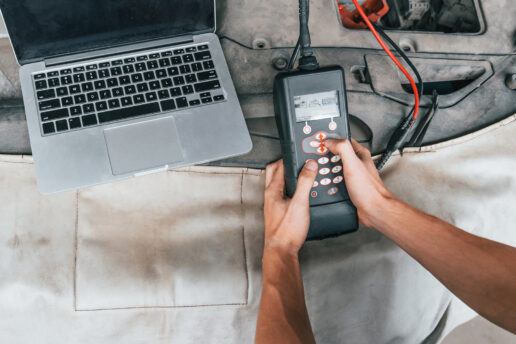 Nottingham Auto Electrics - Who We Are 2 Auto Electrician holing a diagnostic tool for Nottingham Auto Electrics.