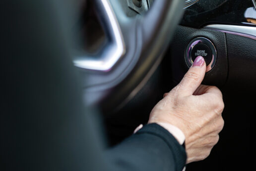 Hand pressing car engine start/stop button - Starter motor repair Nottingham